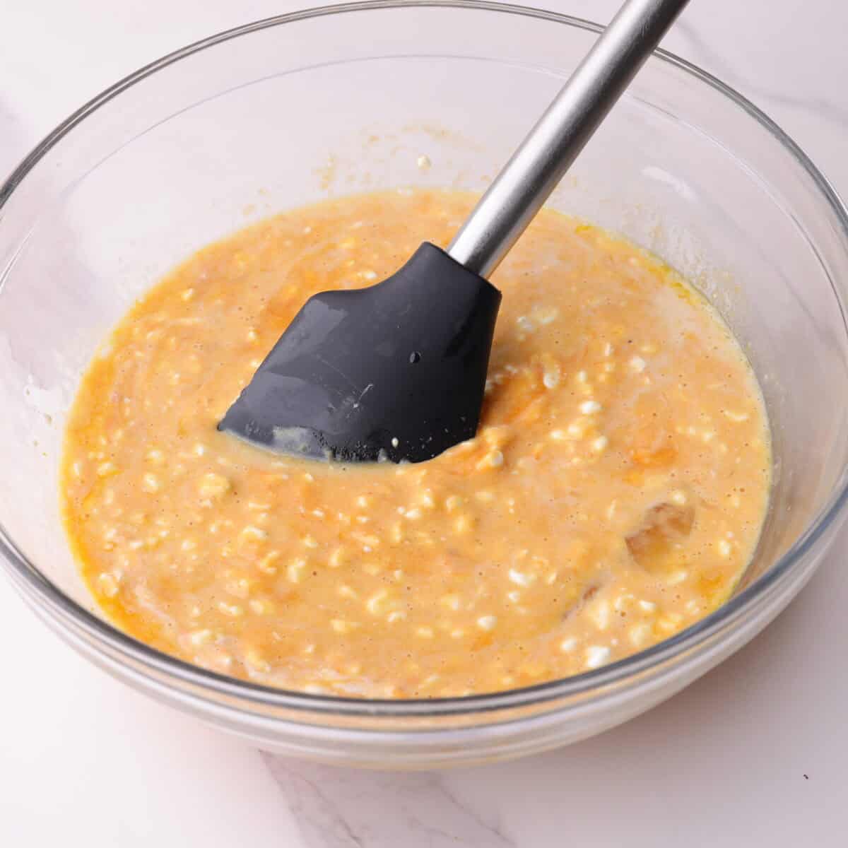 Liquid ingredients combined in a mixing bowl.