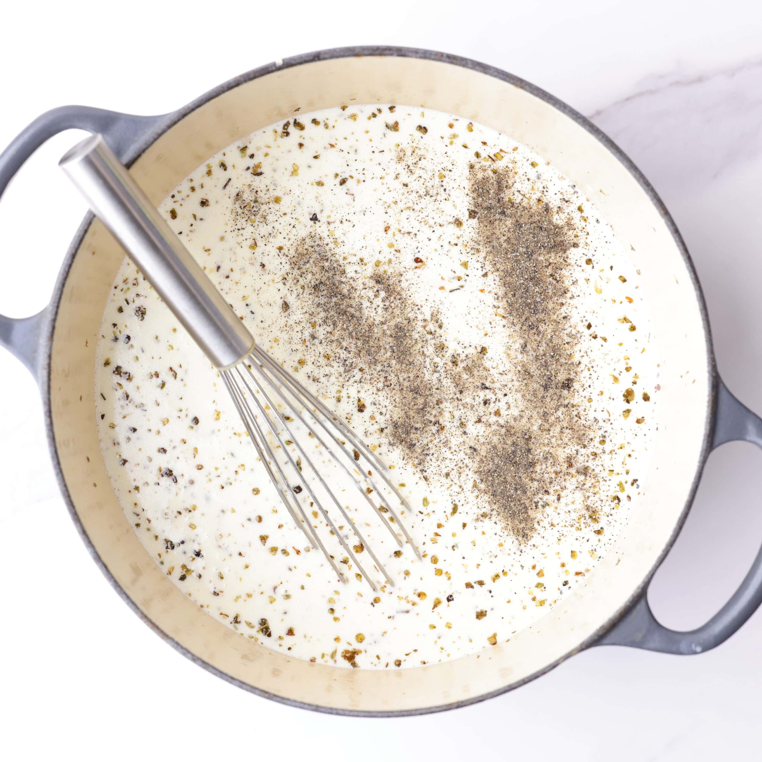 The pot with the melted butter and garlic is now filled with the cream, seasonings and chicken bouillon.
