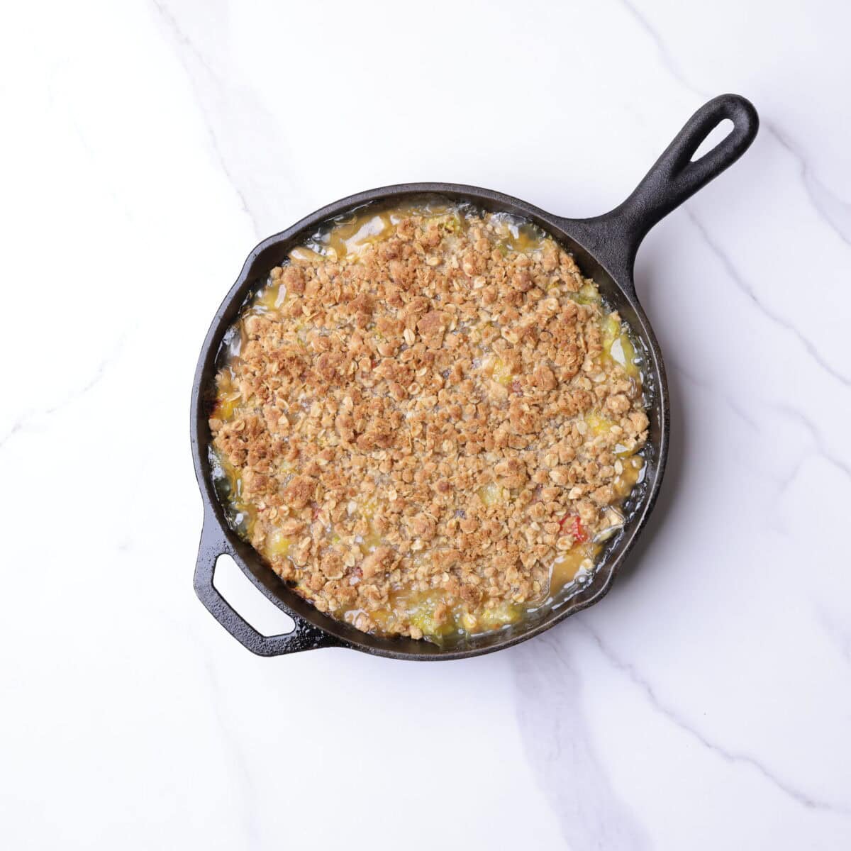 Skillet with golden brown, baked crisp in it.