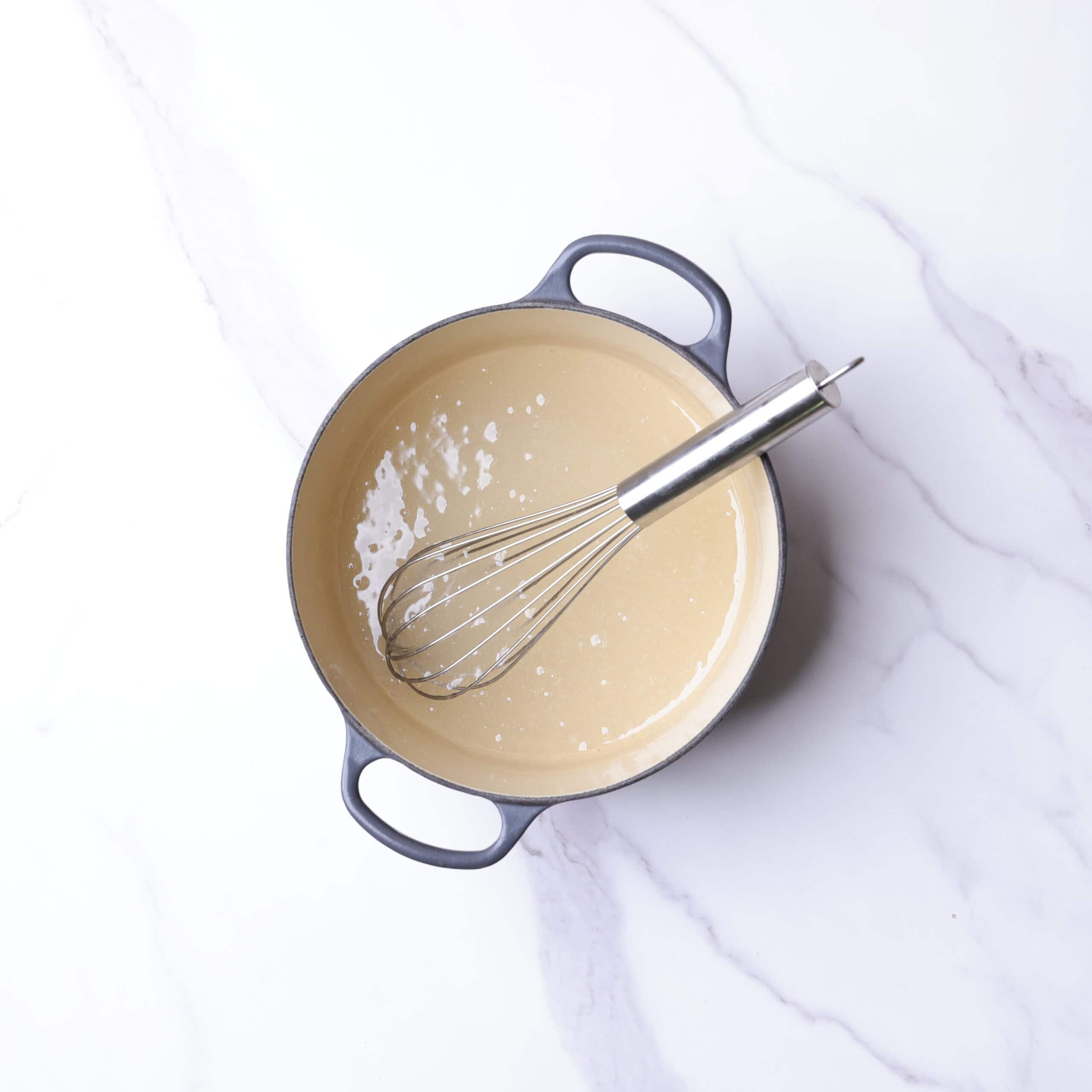 A small pot with thickened sugar and starch mixture in it. 