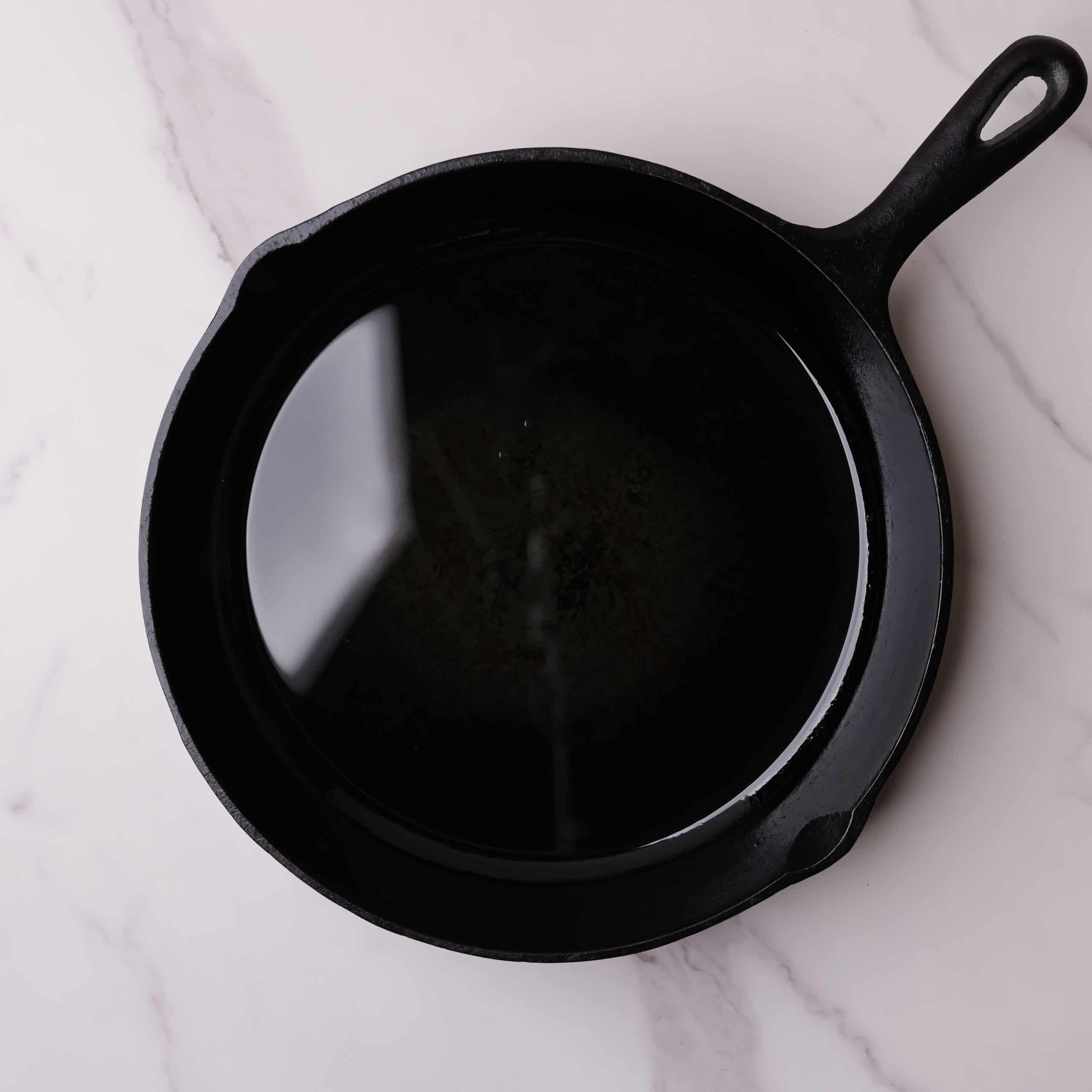 Skillet with oil covering the bottom.