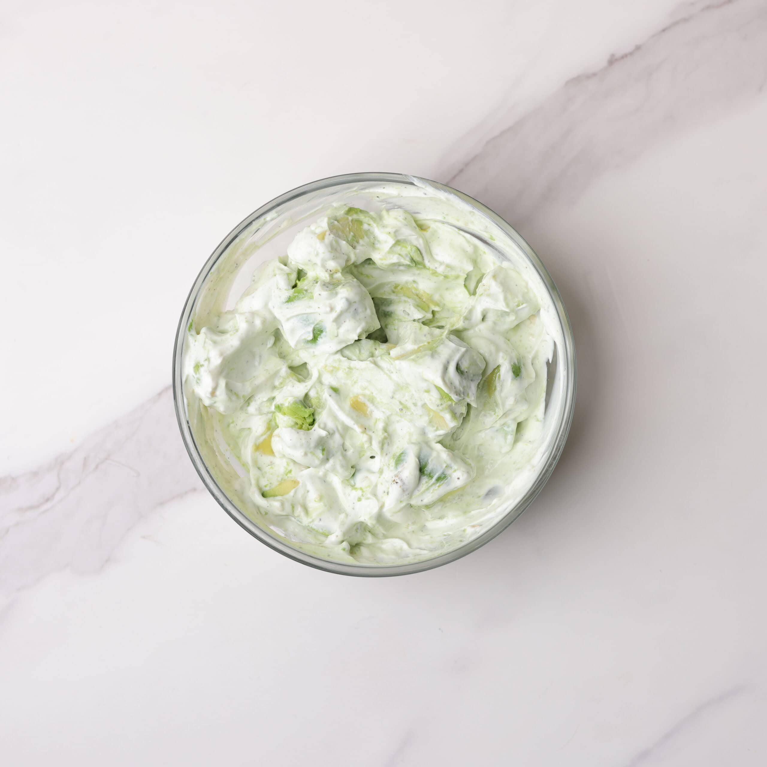 A glass bowl of the combined avocado sauce.