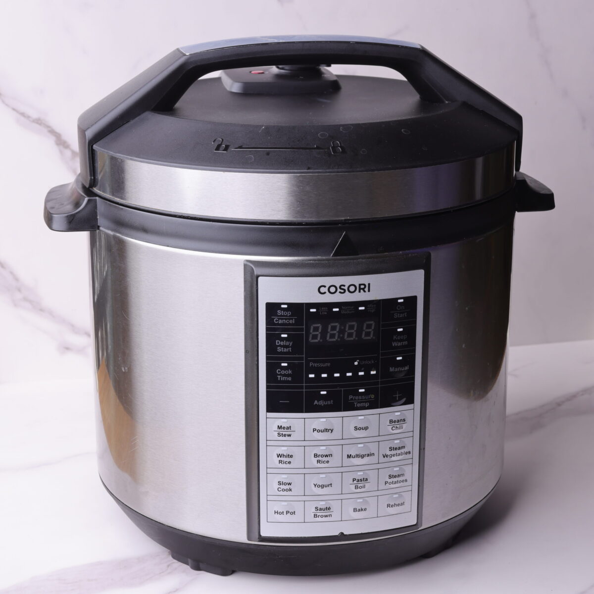 The instant pot with the lid on in the sealed position with the steam valve in the closed position.