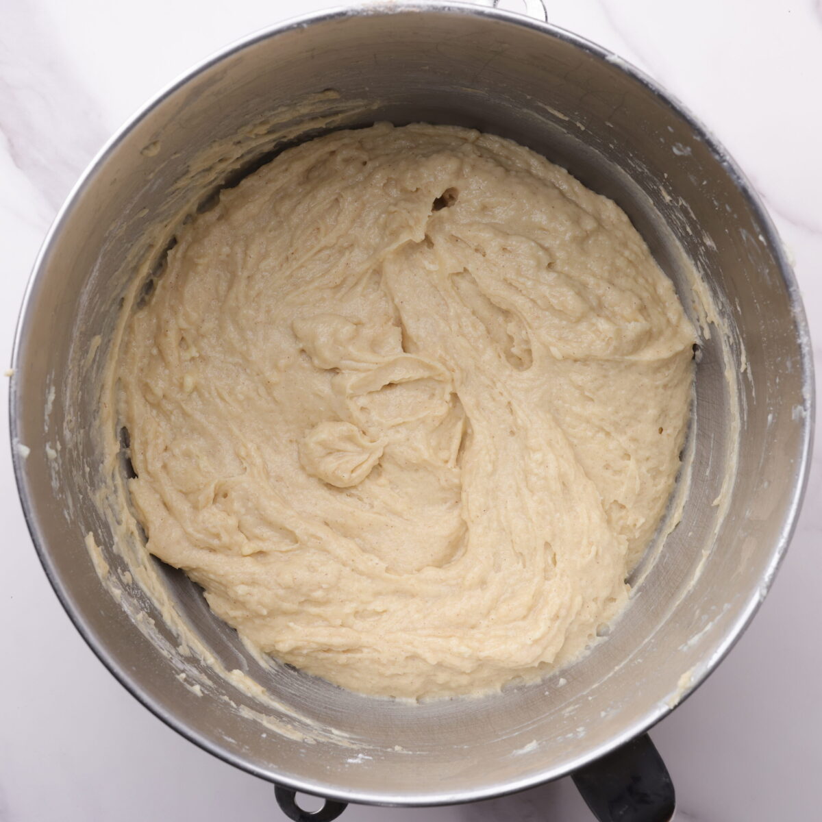 A stand mixer mixing bowl with the finished coffee cake batter in it. 