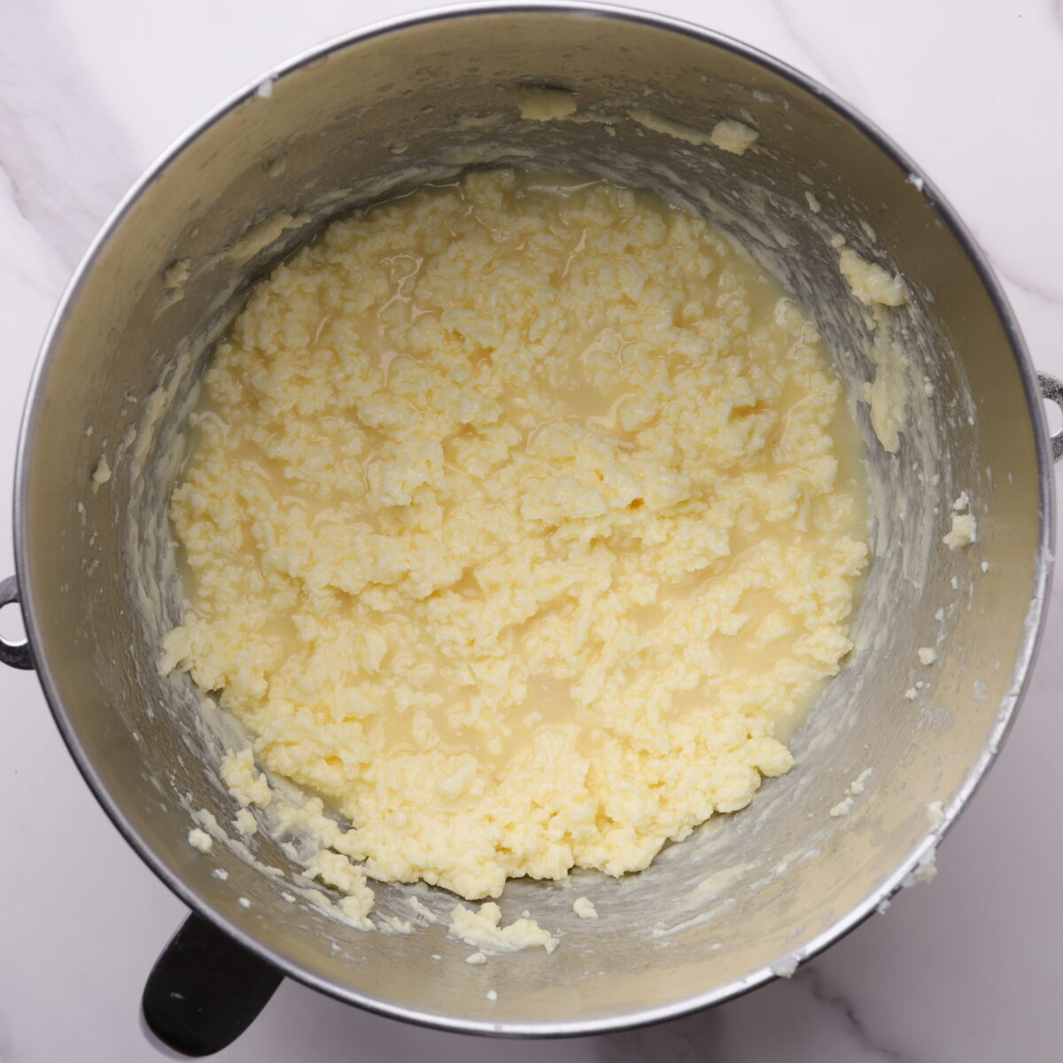 A stand mixer mixing bowl with the wet ingredients combined. 