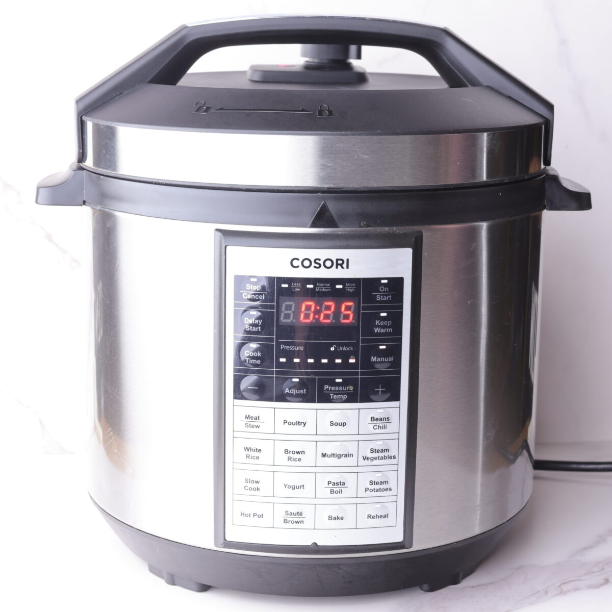 The instant pot on high pressure with the correct time selected for pressure cooking the frozen chicken.