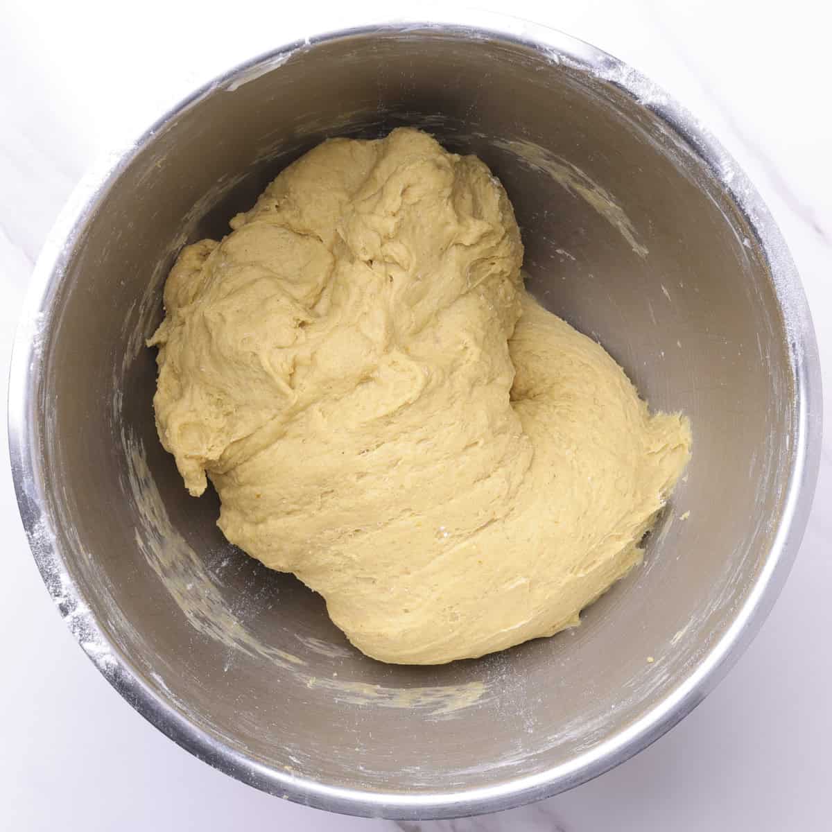 A mixing bowl with the finished dough in it.