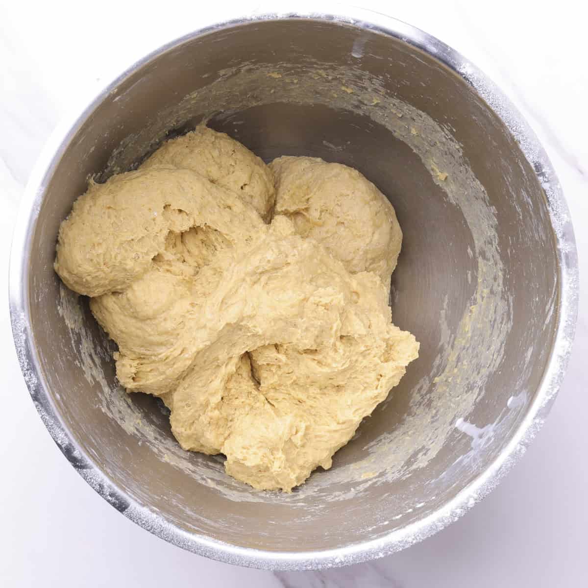 A mixing bowl with the mixed dough prior to adding the butter.