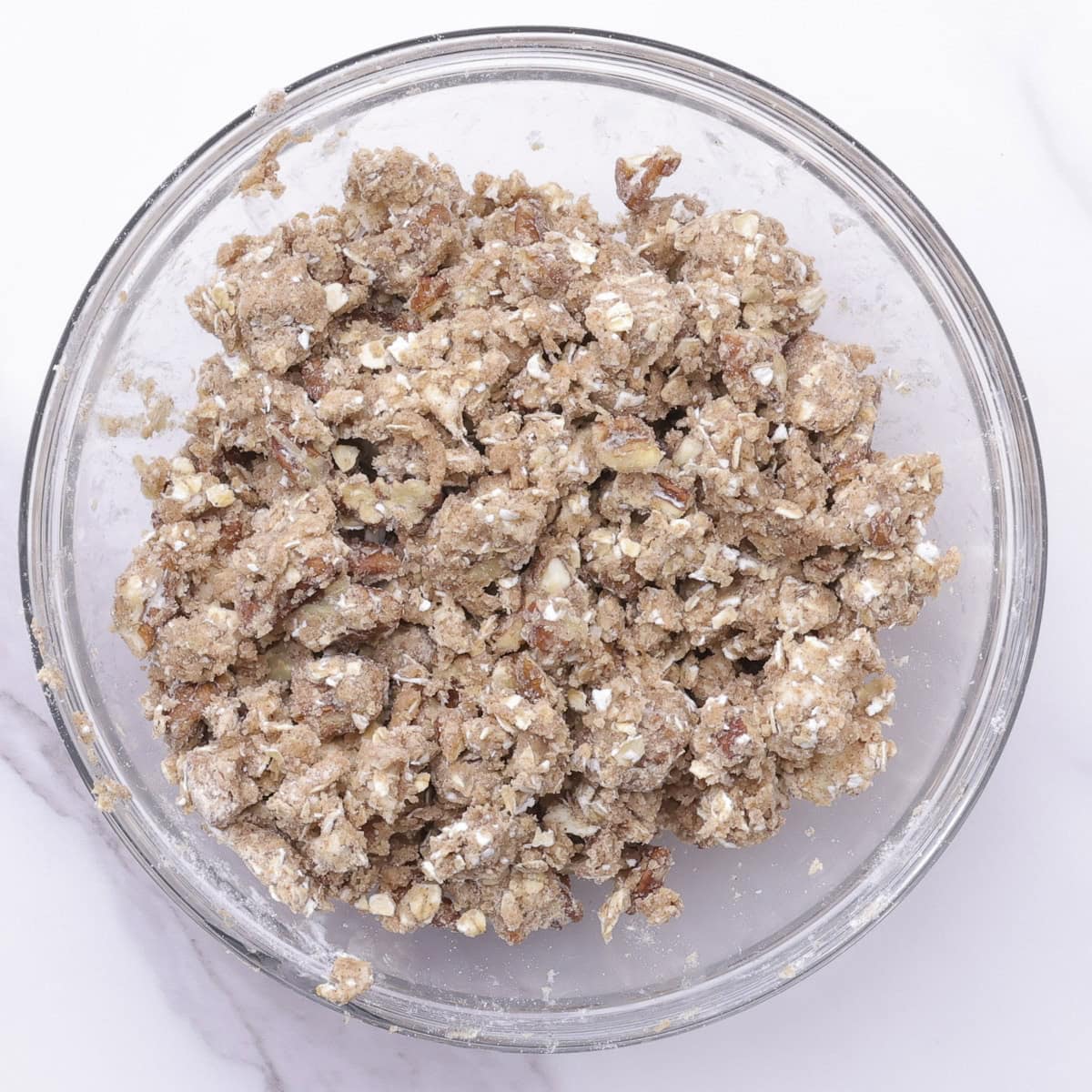A glass bowl with the combined streusel crumb mixture.