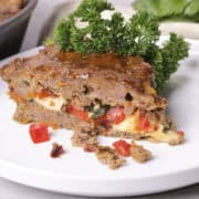 A slice of the Skillet Meatloaf on a white plate, garnished.