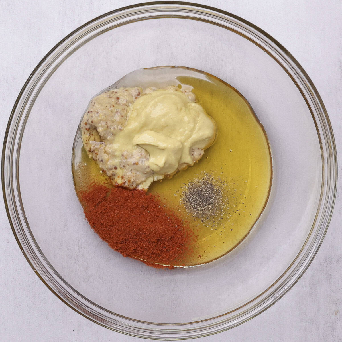 The ingredients for the honey-Dijon topping in a glass bowl.