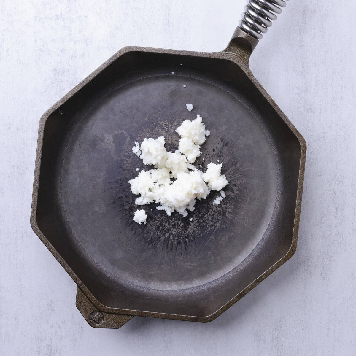 A skillet with beef tallow in it.