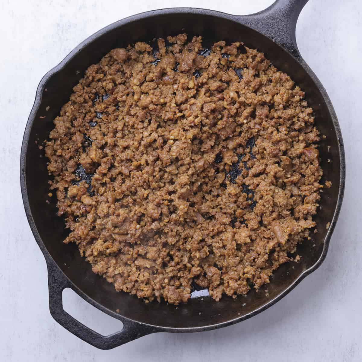 A skillet with fully cooked ground chorizo sausage.