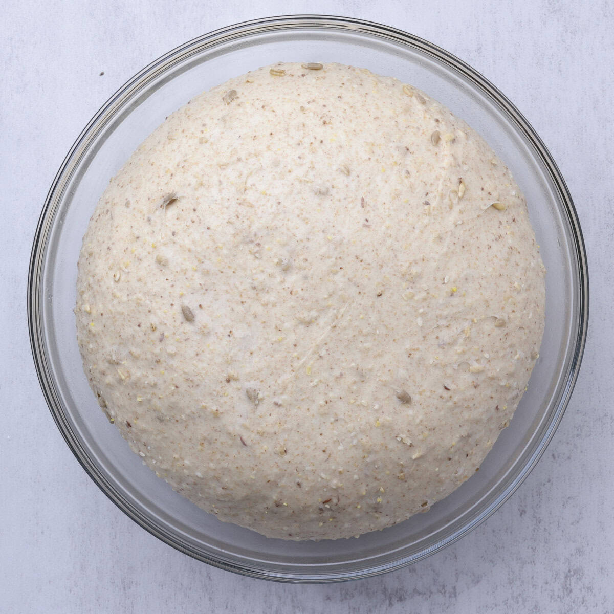 The dough doubled in size in a glass bowl.