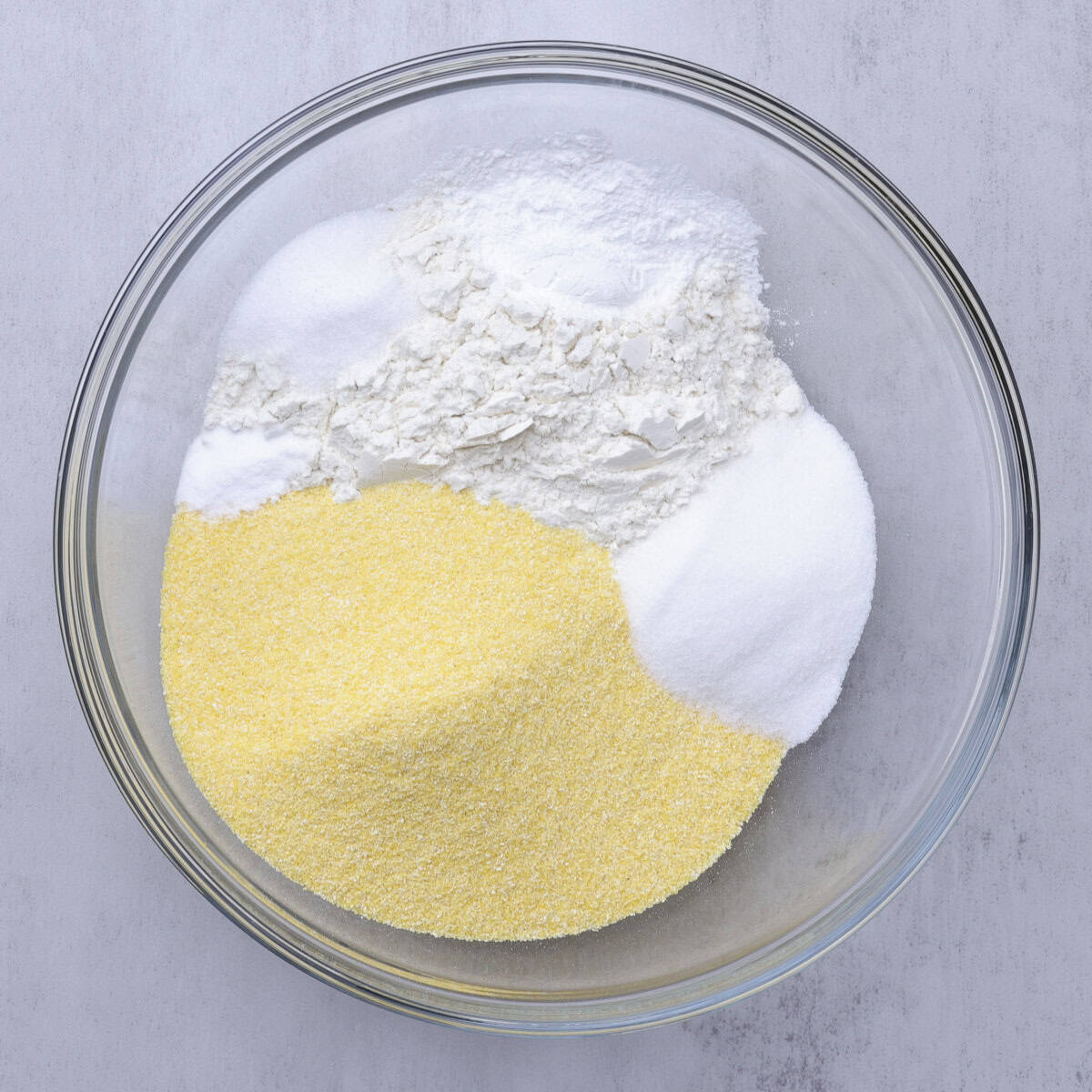 A glass bowl containing all the dry ingredients.