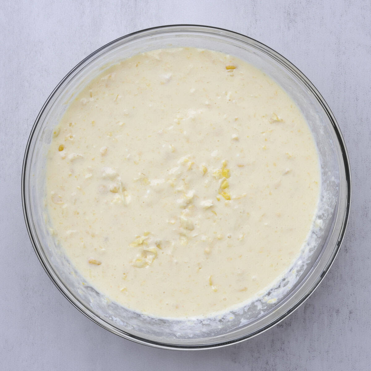 A glass bowl with all the wet ingredients combined.
