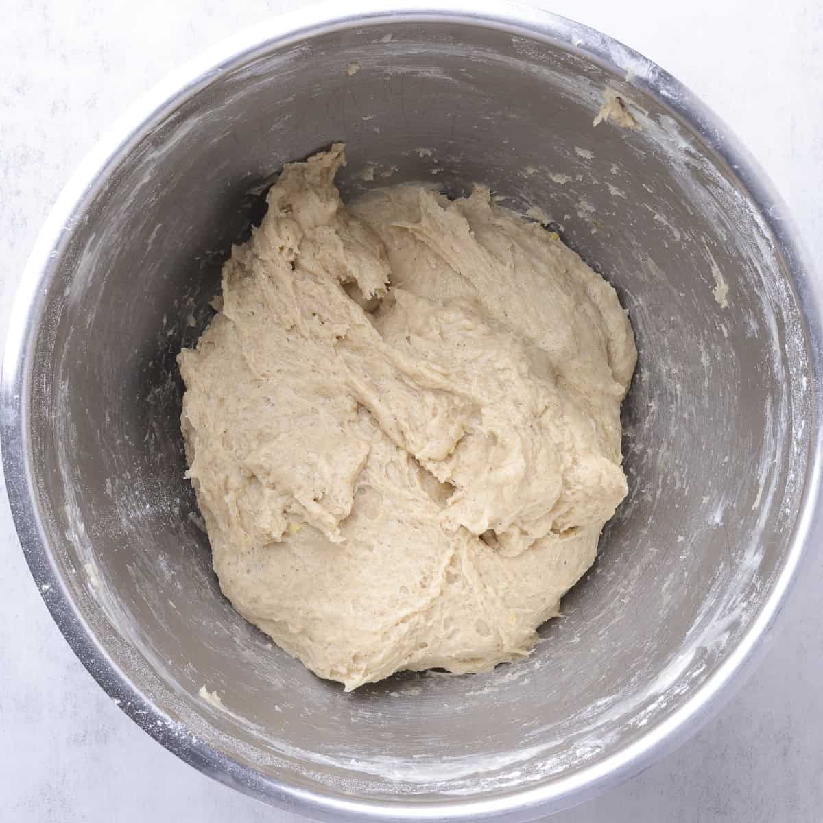 A mixing bowl with a soft dough formed.