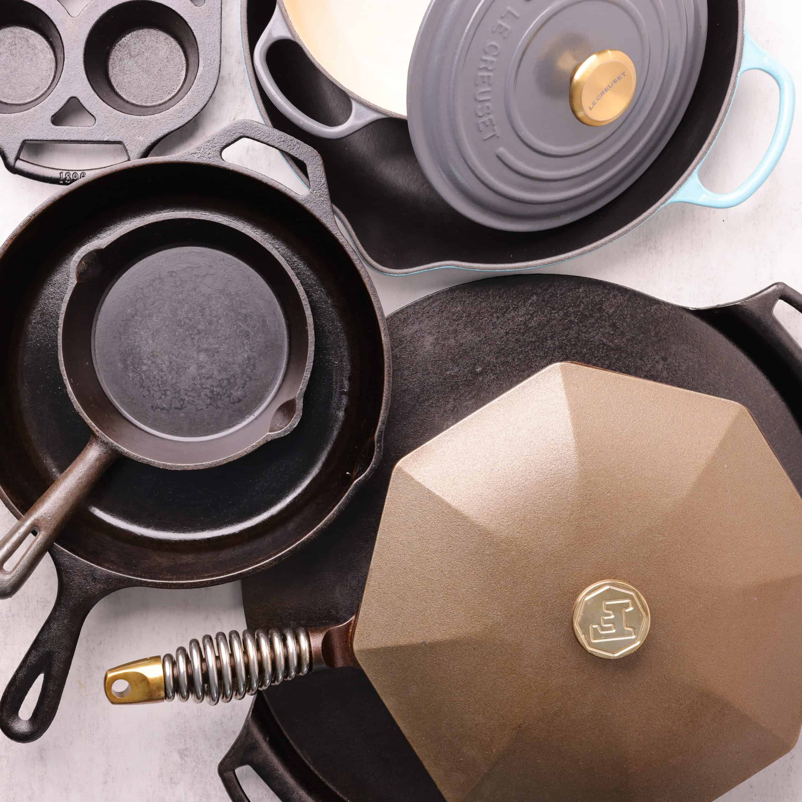 A compilation of many cast iron pots, pans, muffin "tin" and platter.