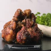 The Sticky Chicken Drumsticks leaning together.