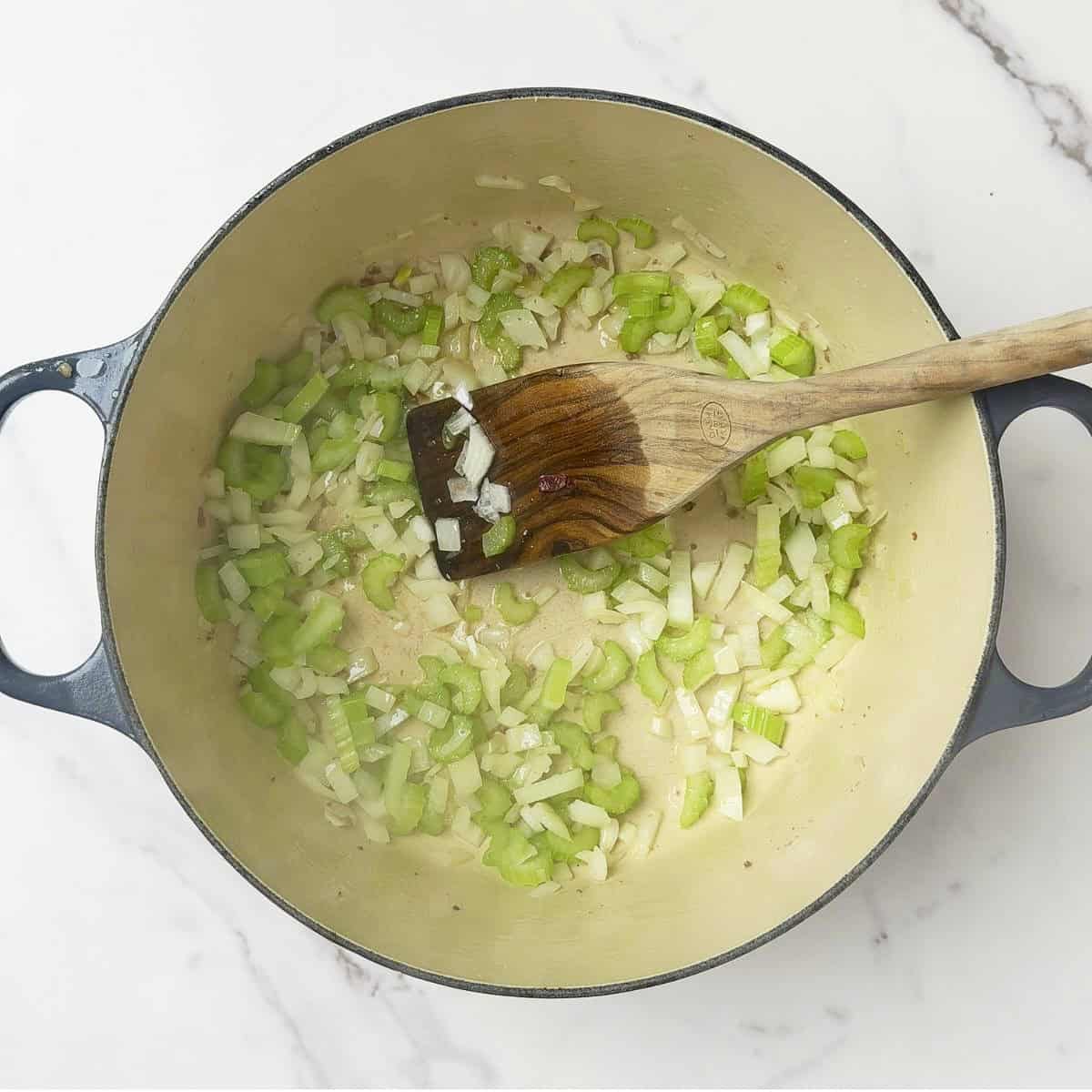 The celery and onions cooking in the pot.
