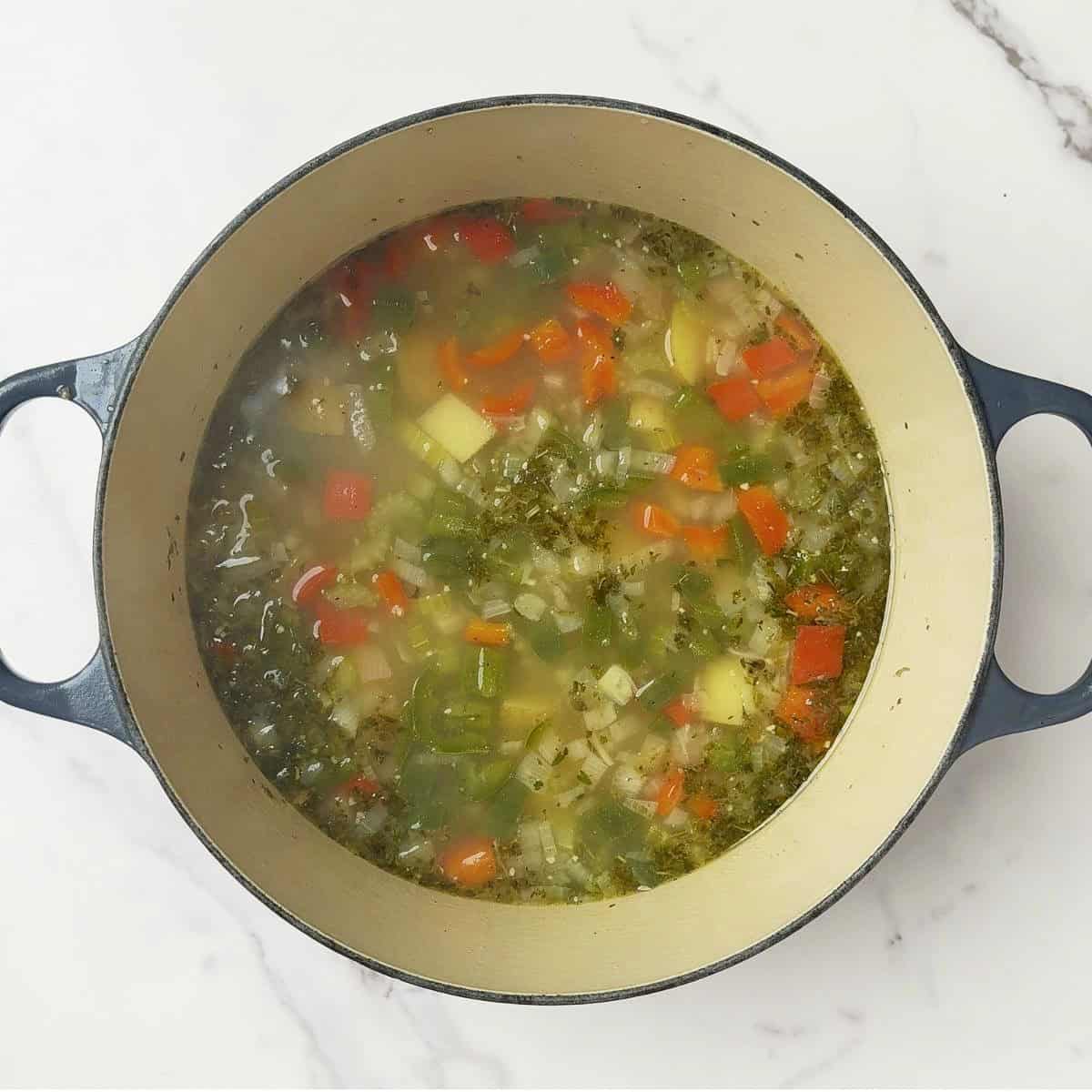 The chicken broth, potatoes and spices added to the pot.