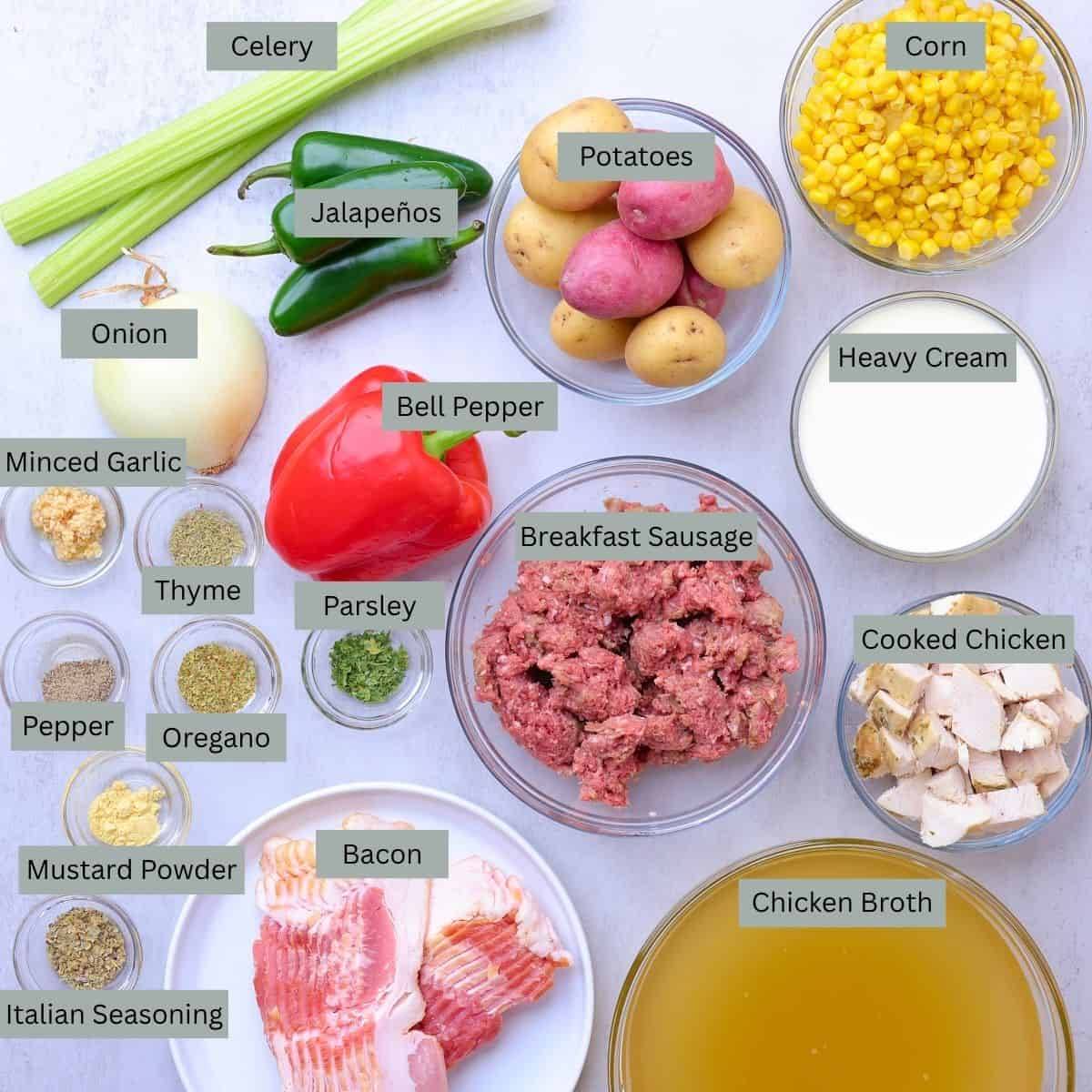 A visual display of the ingredients needed for the Chicken and Sausage Soup - celery, jalapeños, potatoes, corn, onion, bell pepper, breakfast sausage, heavy cream, cooked chicken, chicken broth, bacon, minced garlic, Italian seasoning, mustard powder, thyme, oregano, parsley and pepper.