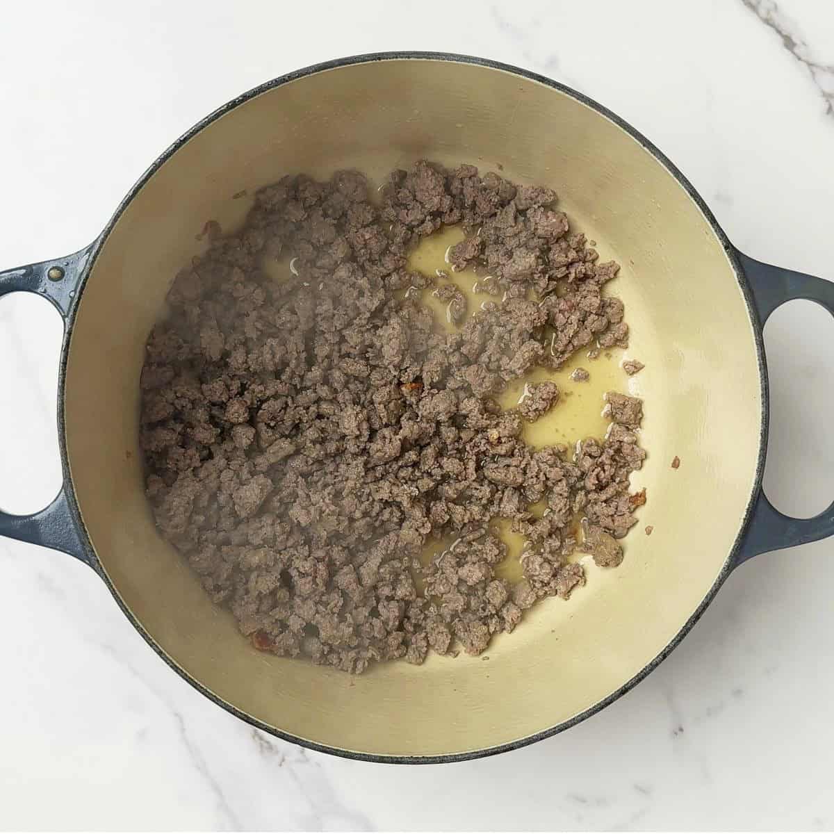 The sausage browned in the pot.