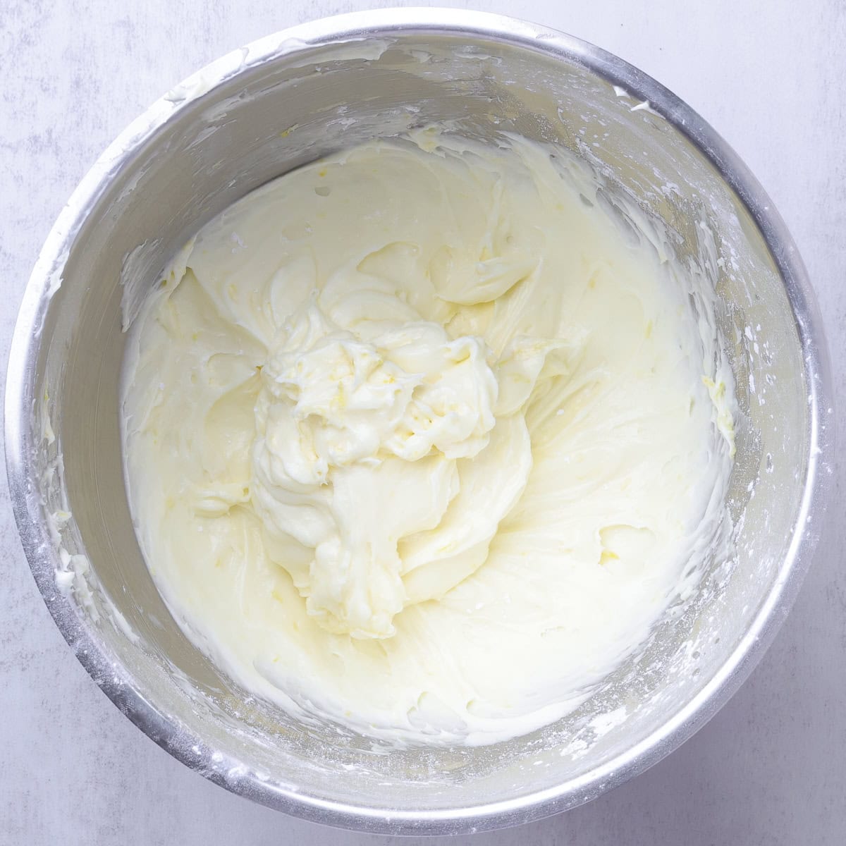 A mixing bowl containing the fluffy and smooth Lemon Cream Cheese Icing.