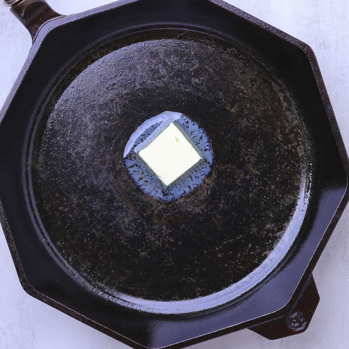 A hot skillet with butter melting in it.