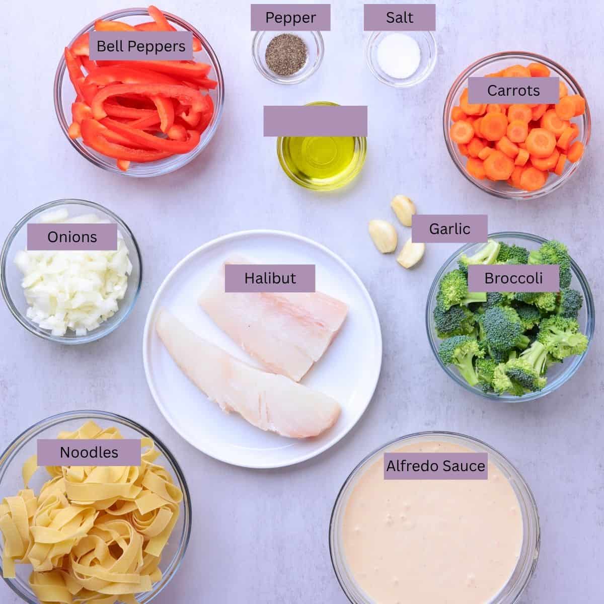 A visual display of the ingredients needed for the Halibut Pasta - bell peppers, salt, pepper, olive oil, garlic, carrots, onions, halibut, broccoli, pasta noodles and Alfredo sauce - each displayed in their own bowl.