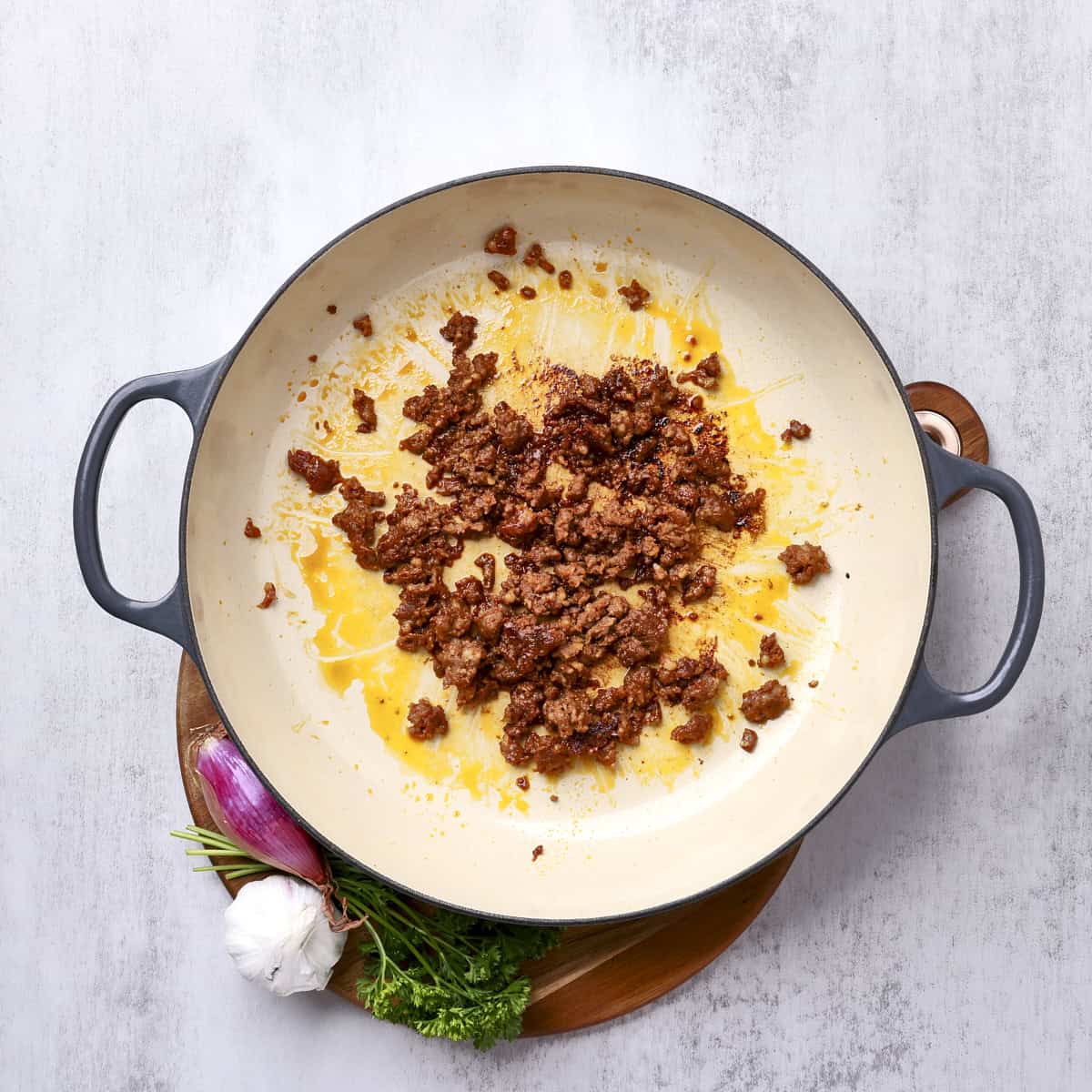 A large pan with the browned chorizo sausage.