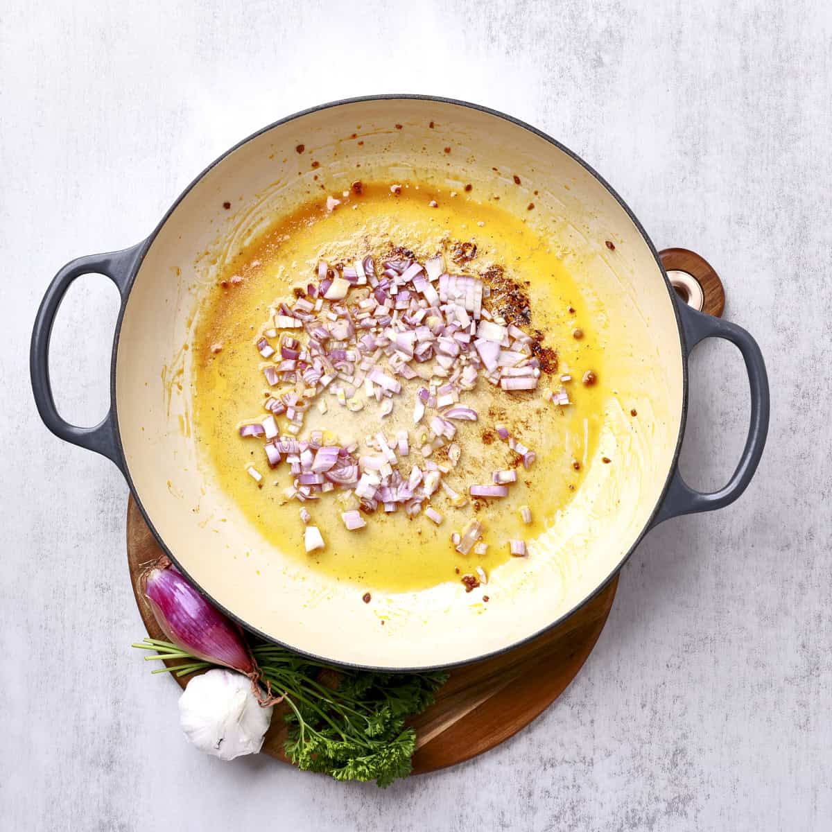 A large pan with the chopped shallot and garlic sauteing.