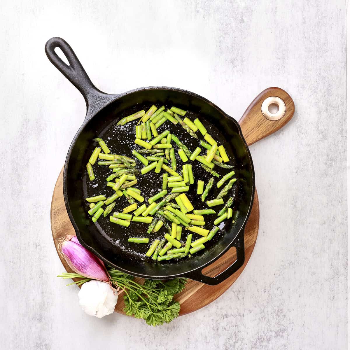 A skillet with the chopped, cooked asparagus.