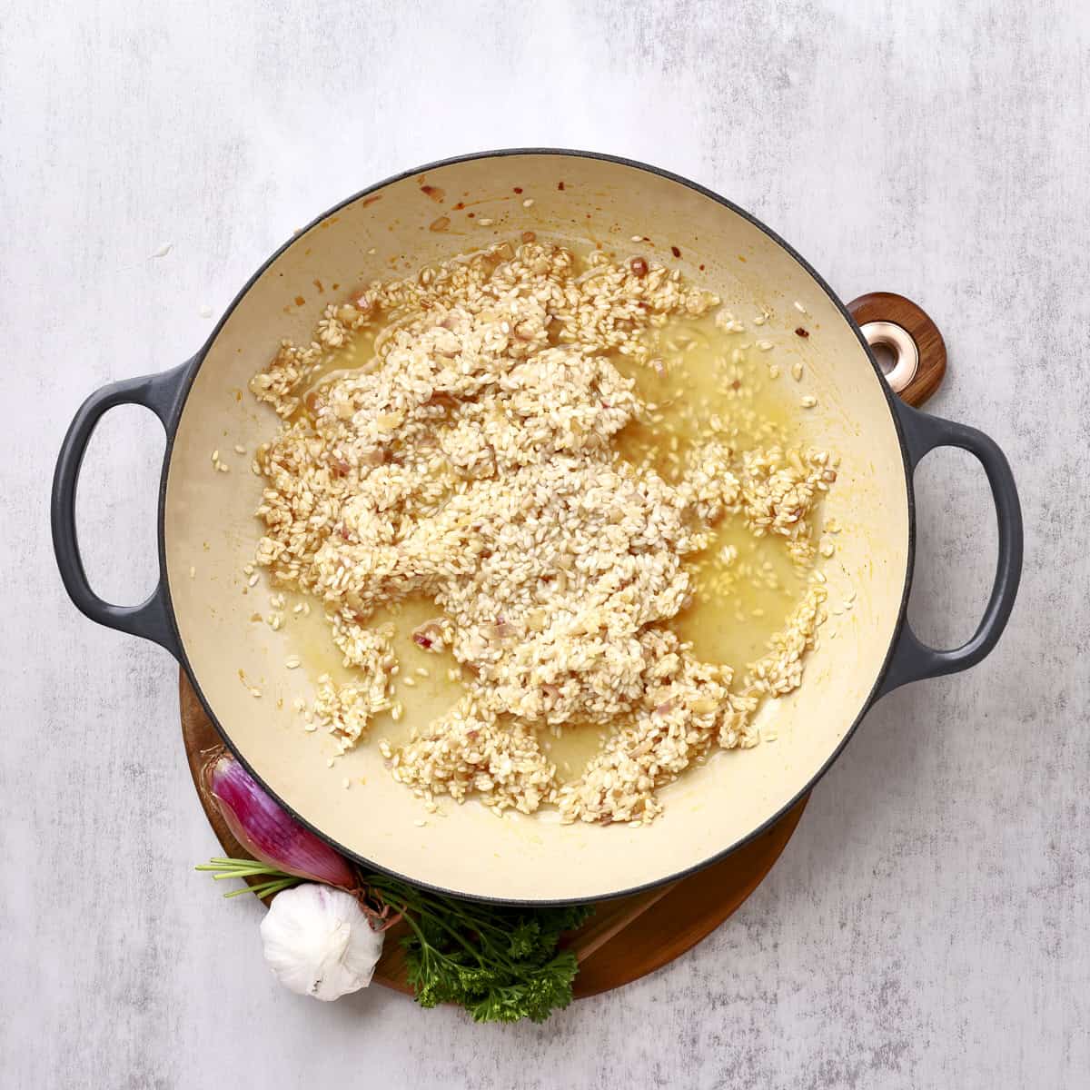 A large pan with the rice and wine poured over it.