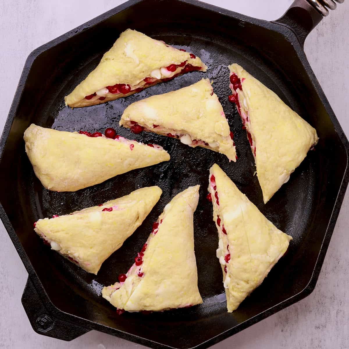 A skillet filled with the cut, unbaked scones.