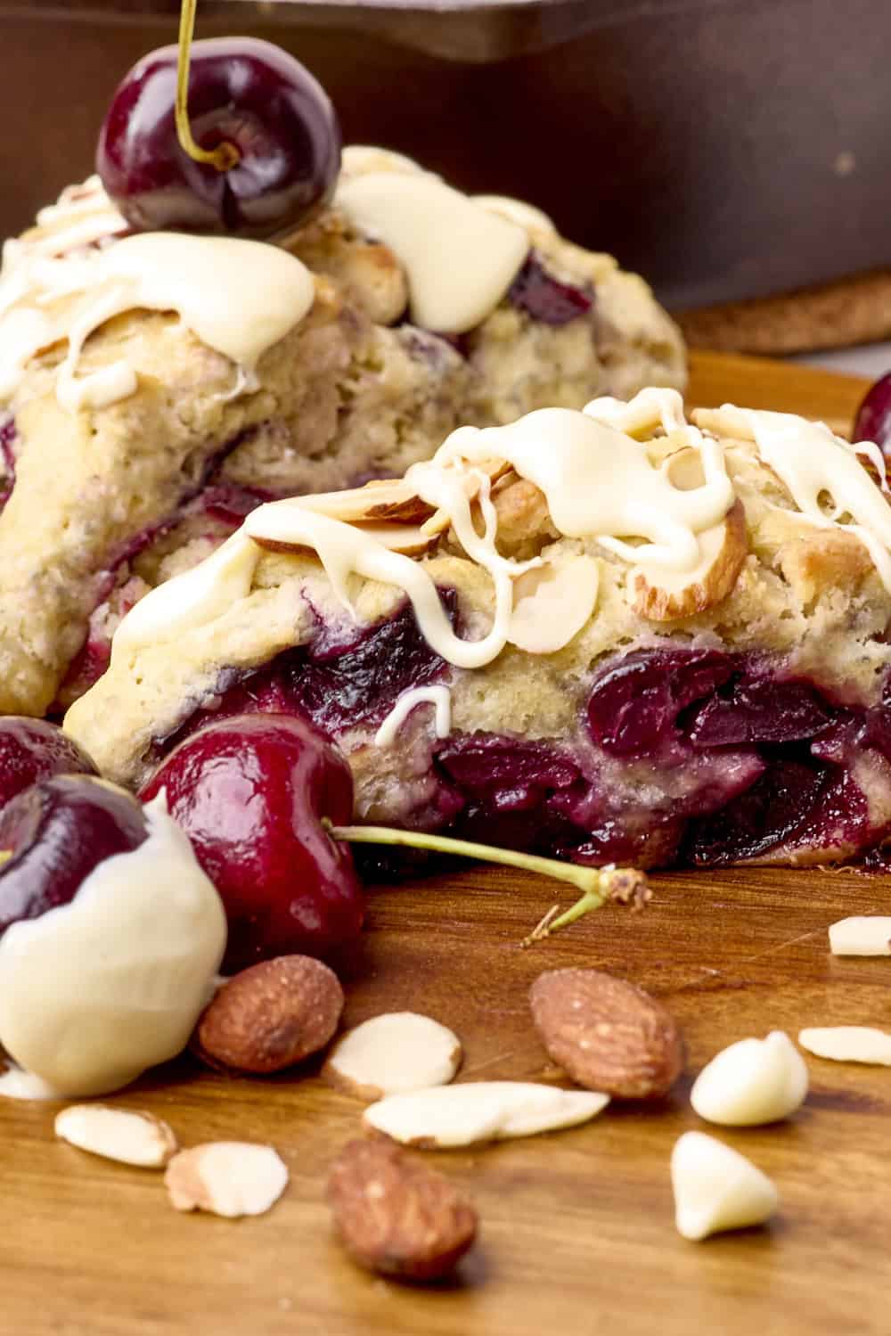 Two Cherry Scones displayed on a wooden board, with the side of the front one visible.