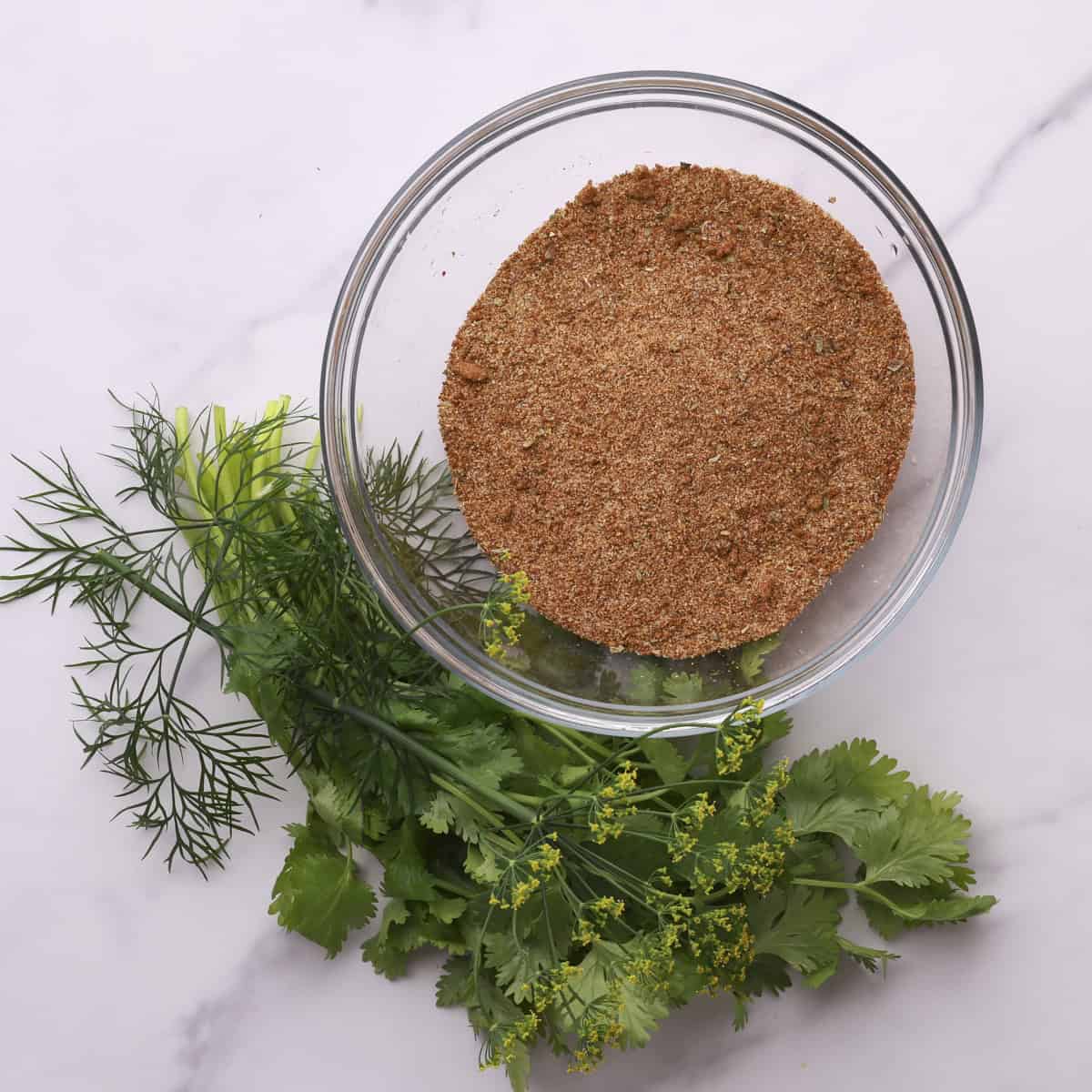 A bowl of the Salmon Spice mixed together and displayed with greens.