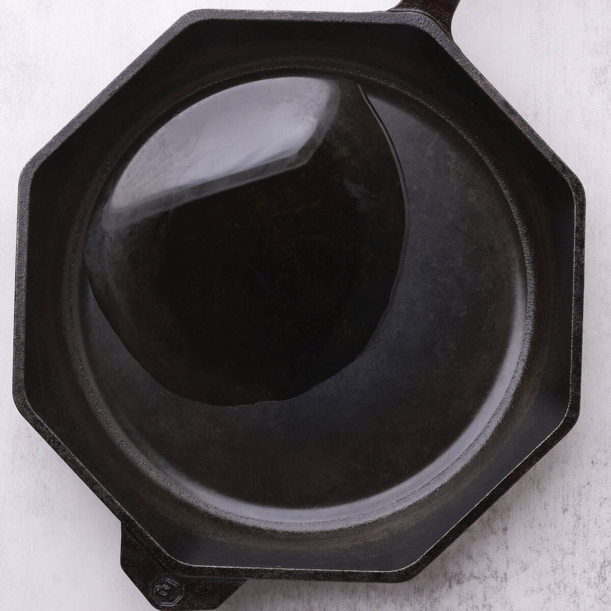 A skillet with oil covering the bottom.